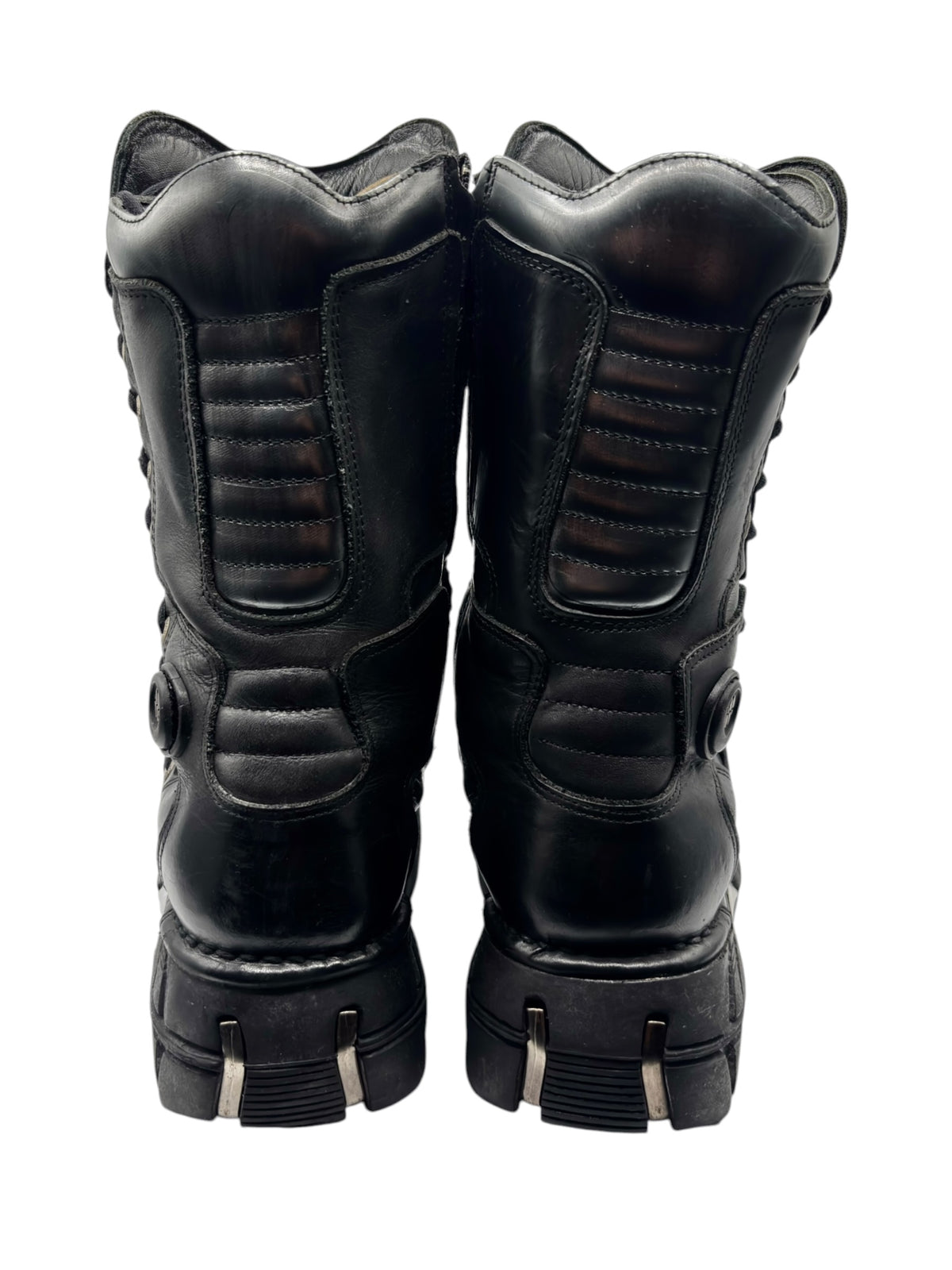 Black tall boots with padded ankle, quilted panels, and platform heel base
