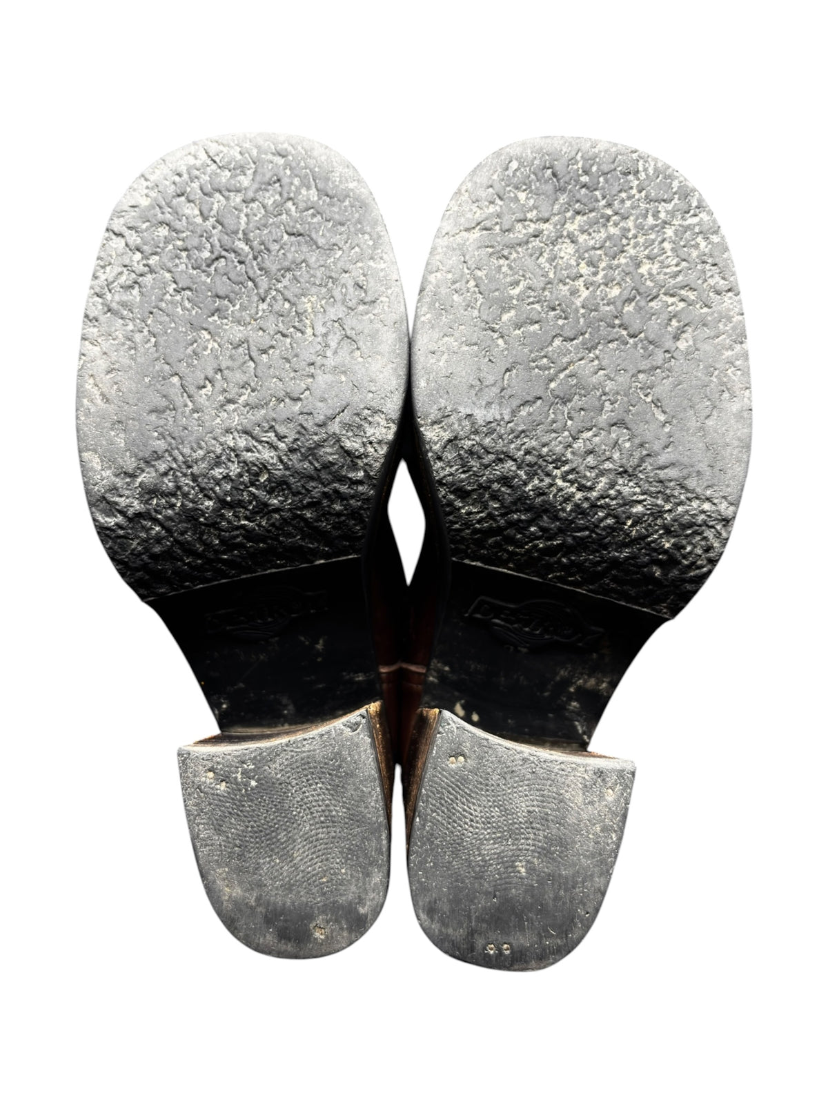 Boot soles view with textured tread and worn, light insides.