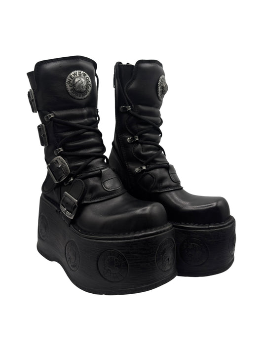Black leather platform boots with buckles, laces, and raised circular tread details