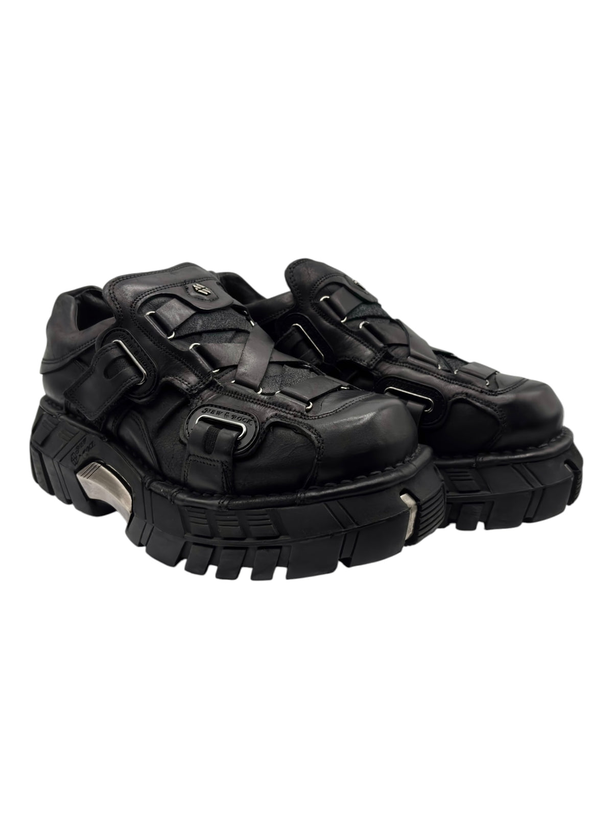Black platform boots with thick tread sole, side straps, and buckle accents