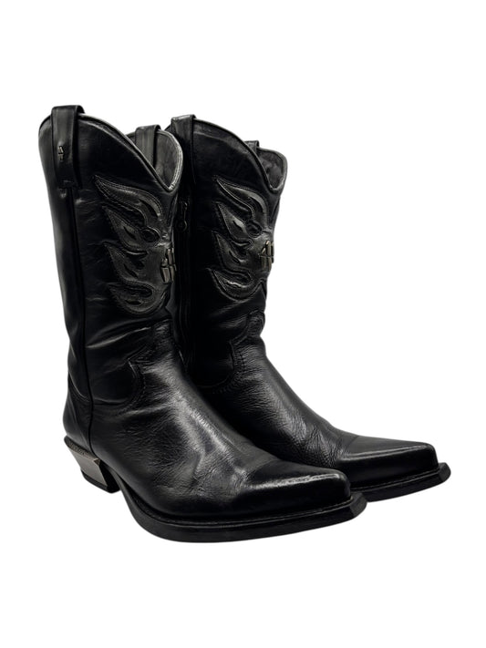Black leather cowboy boots, side view, pointed toe, stacked heel, embossed western emblem