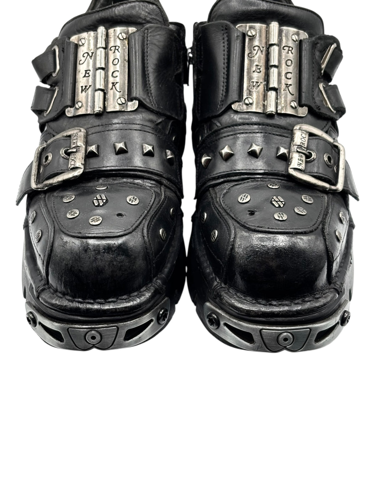 Black studded platform boots with metal buckle straps and raised toe panels