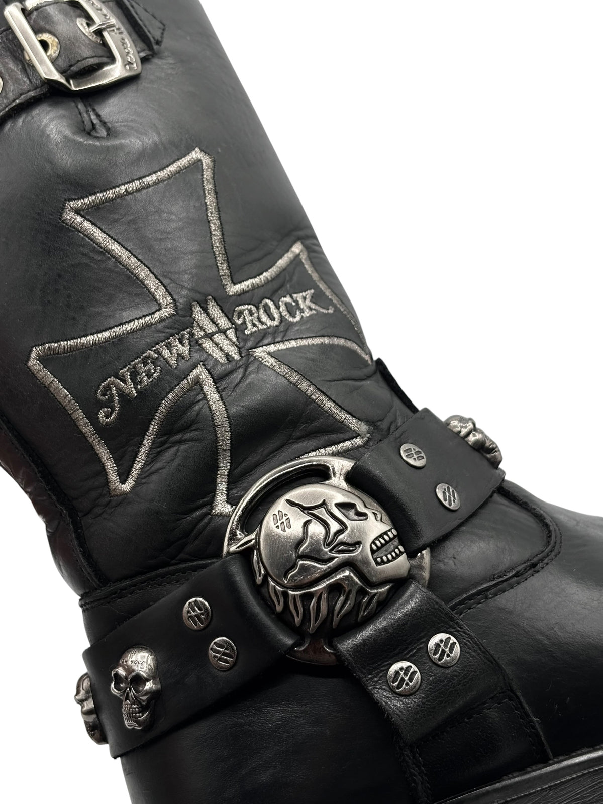 Black leather biker boots close-up of star logo and skull buckle strap