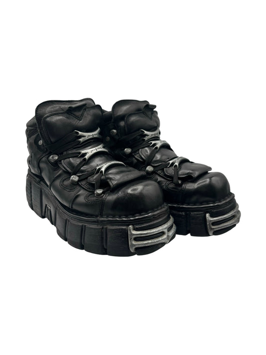 Black platform lace-up boots with textured overlays and silver hardware