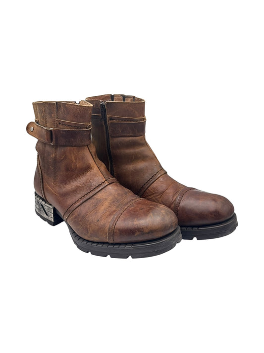 Brown leather ankle boots with buckle strap and rugged tread sole, side zip