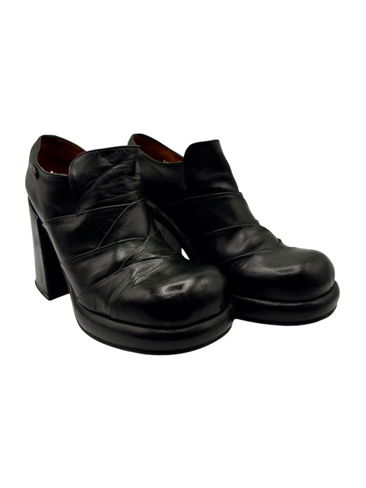 Black leather block platform heels with almond toe and ankle boot silhouette
