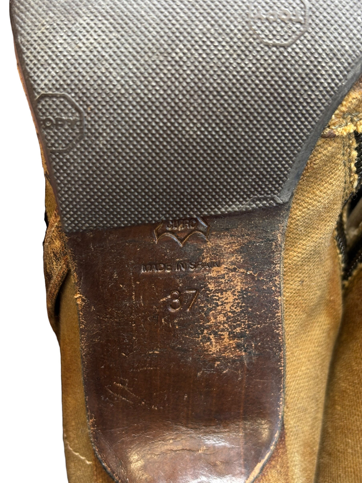Close-up of boot heel counter and tan upper with textured sole