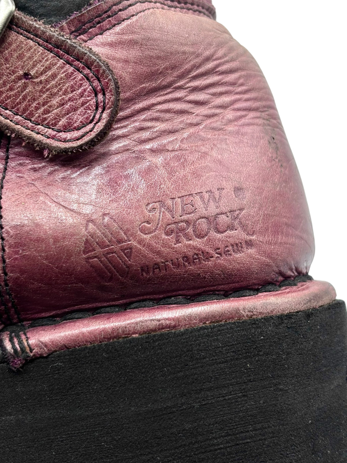 Burgundy boot upper close-up with New Rock embossed logo on side