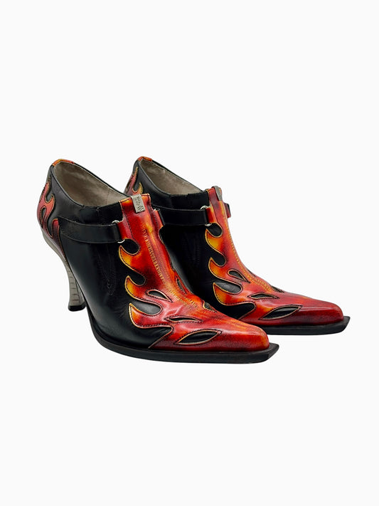 Black leather flame-printed heeled boots with side straps and buckle details