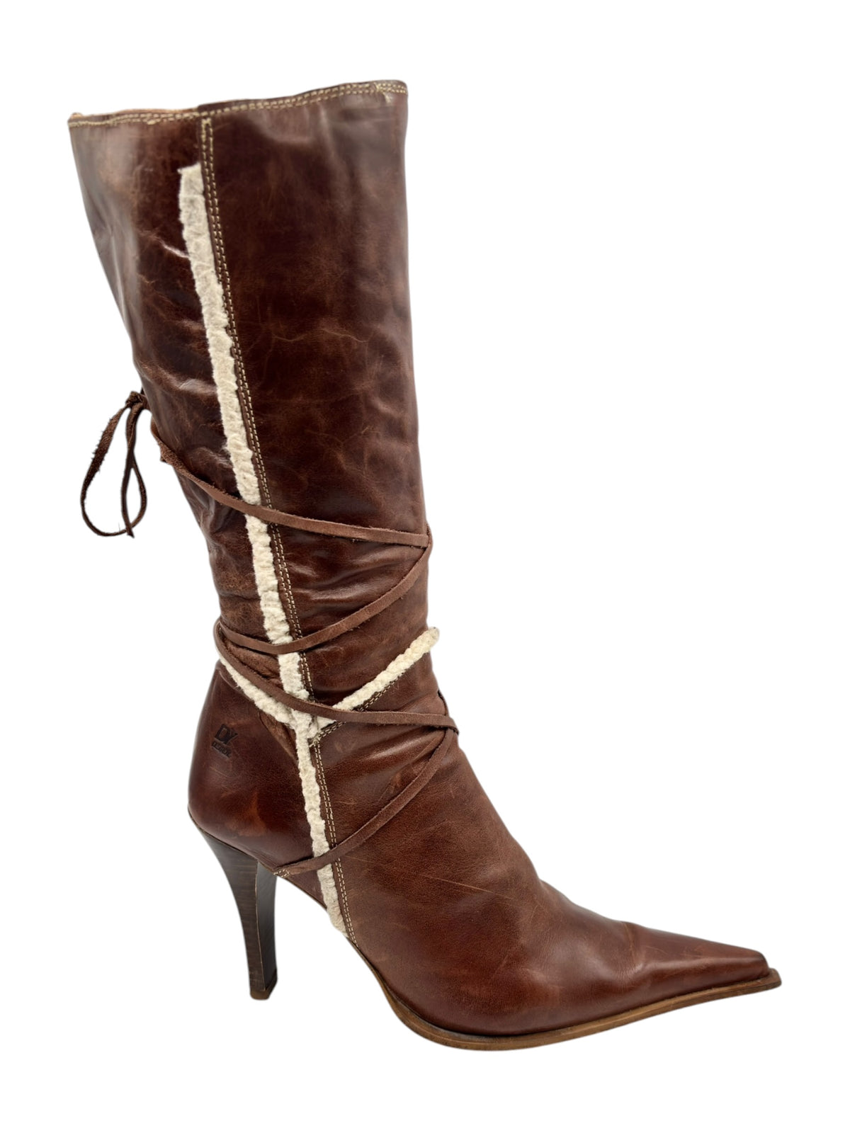 Brown tall leather boots with pointy toe, crisscross lace wrap, and shearling trim.