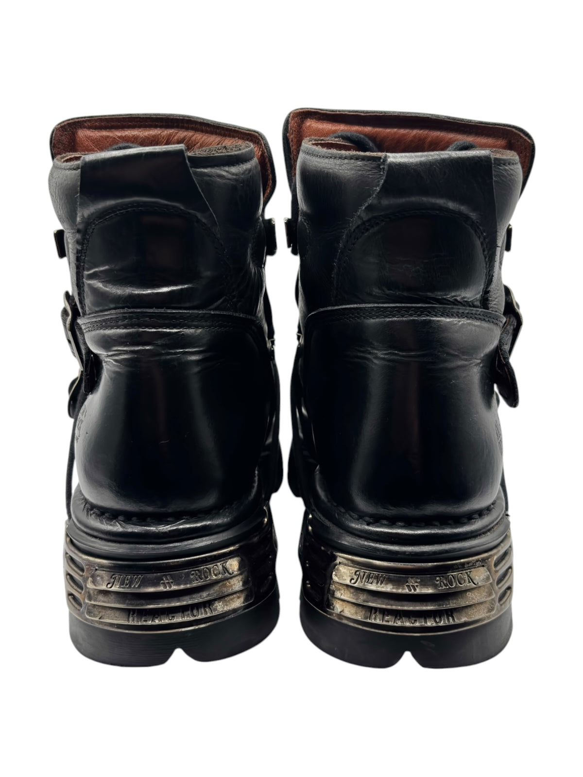 Back view of black ankle boots with adjustable strap tabs and layered outsole