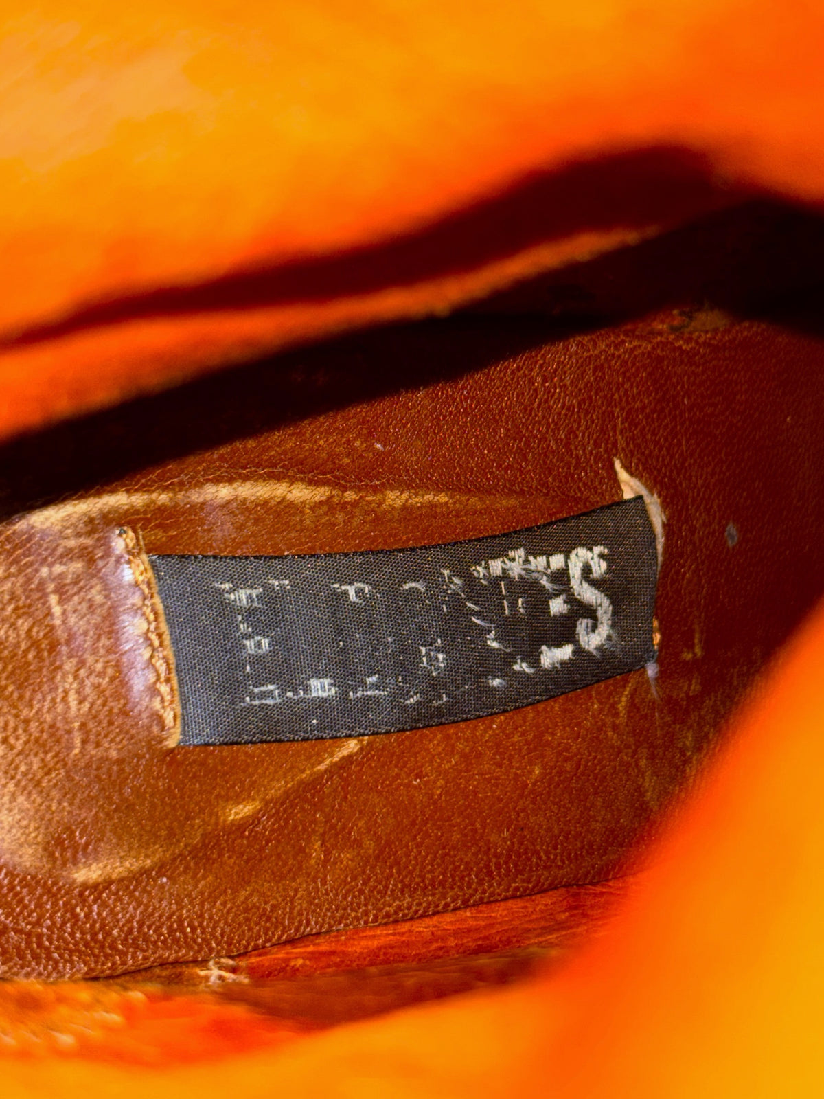 Knee-high platform boot interior label, dark gray tag with El Dantes text