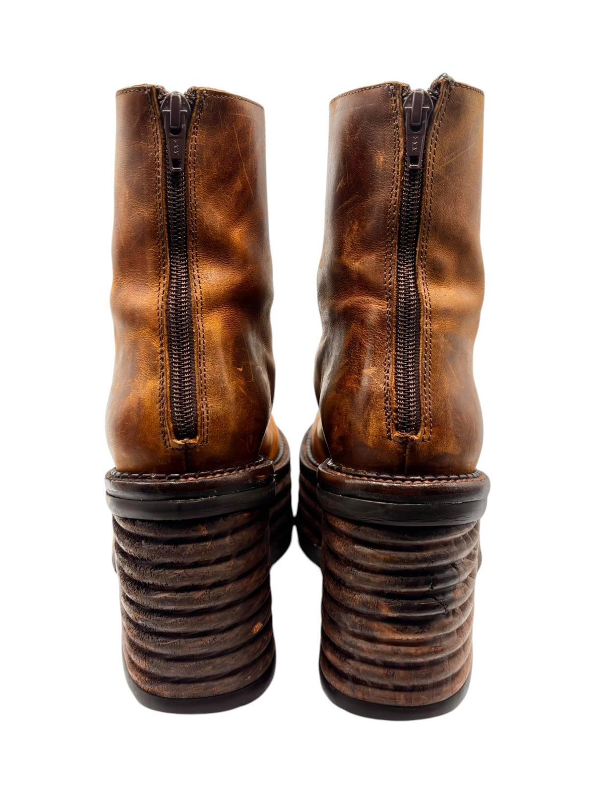Brown leather boots pair with side zippers and stacked block platform soles