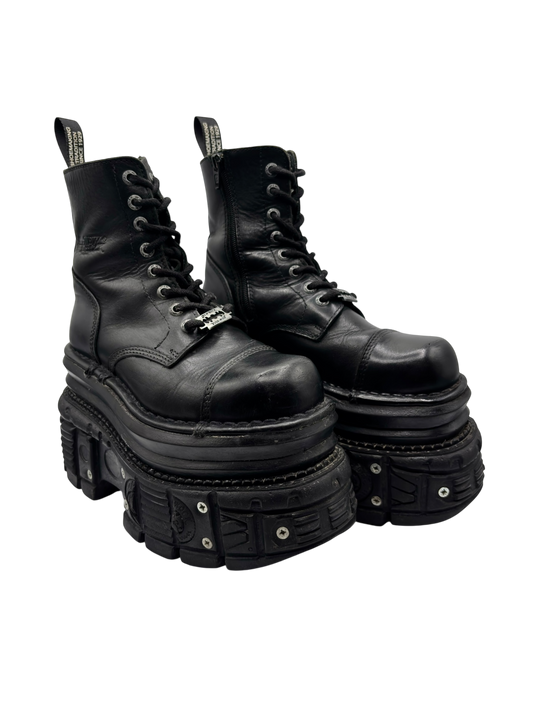 Black leather lace-up platform boots angled view with studded trim on sole