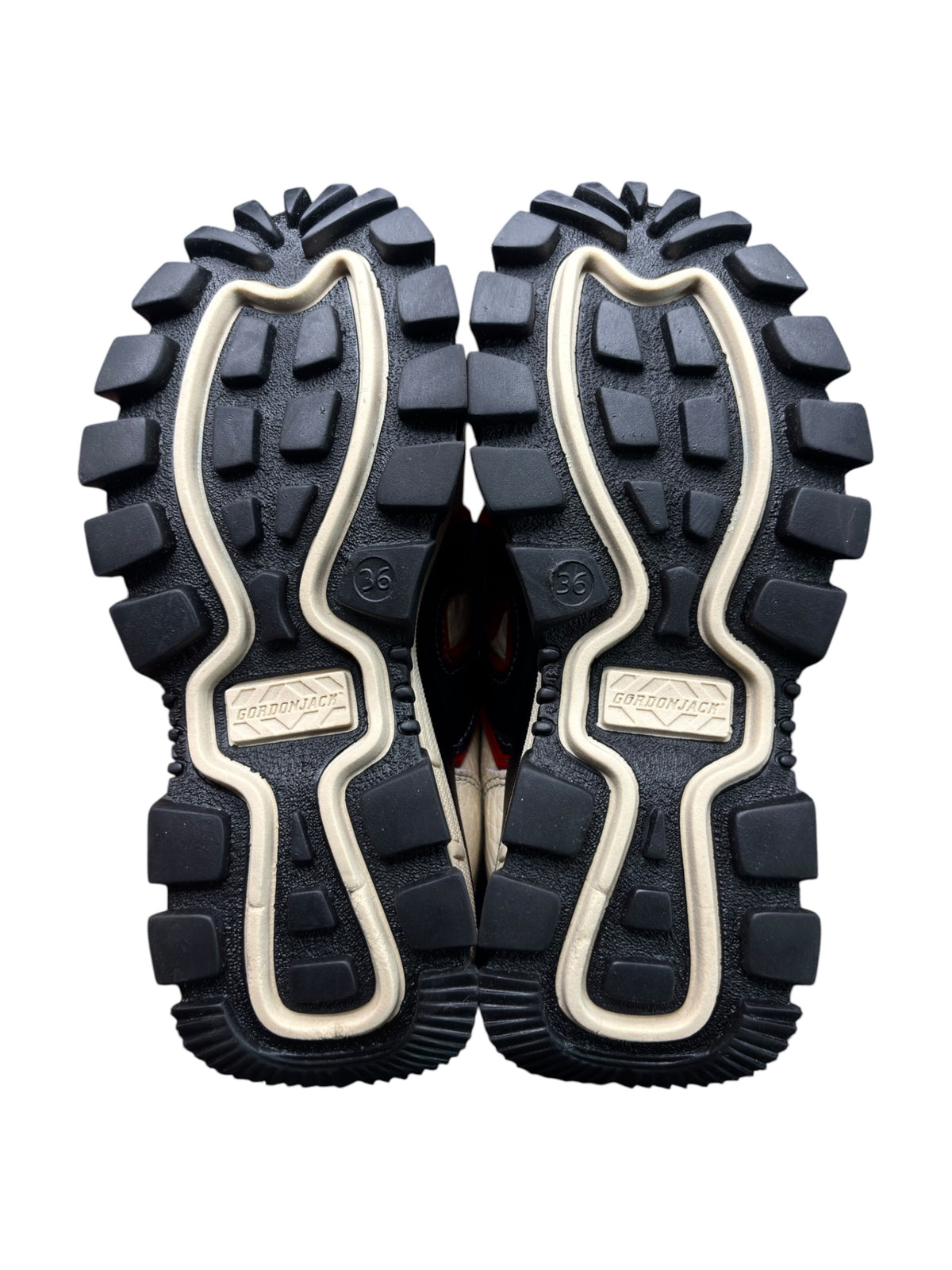 Pair of rugged outsoles with deep tread and cream edge trim