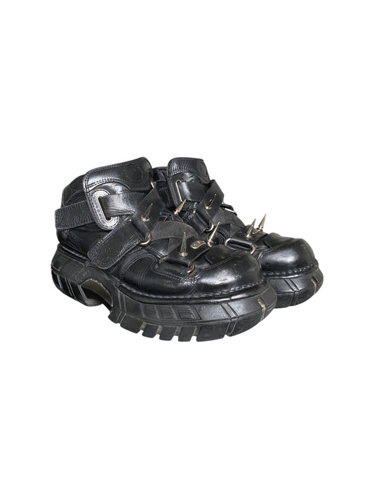 Black spiked platform boots with buckle straps and chunky tread sole