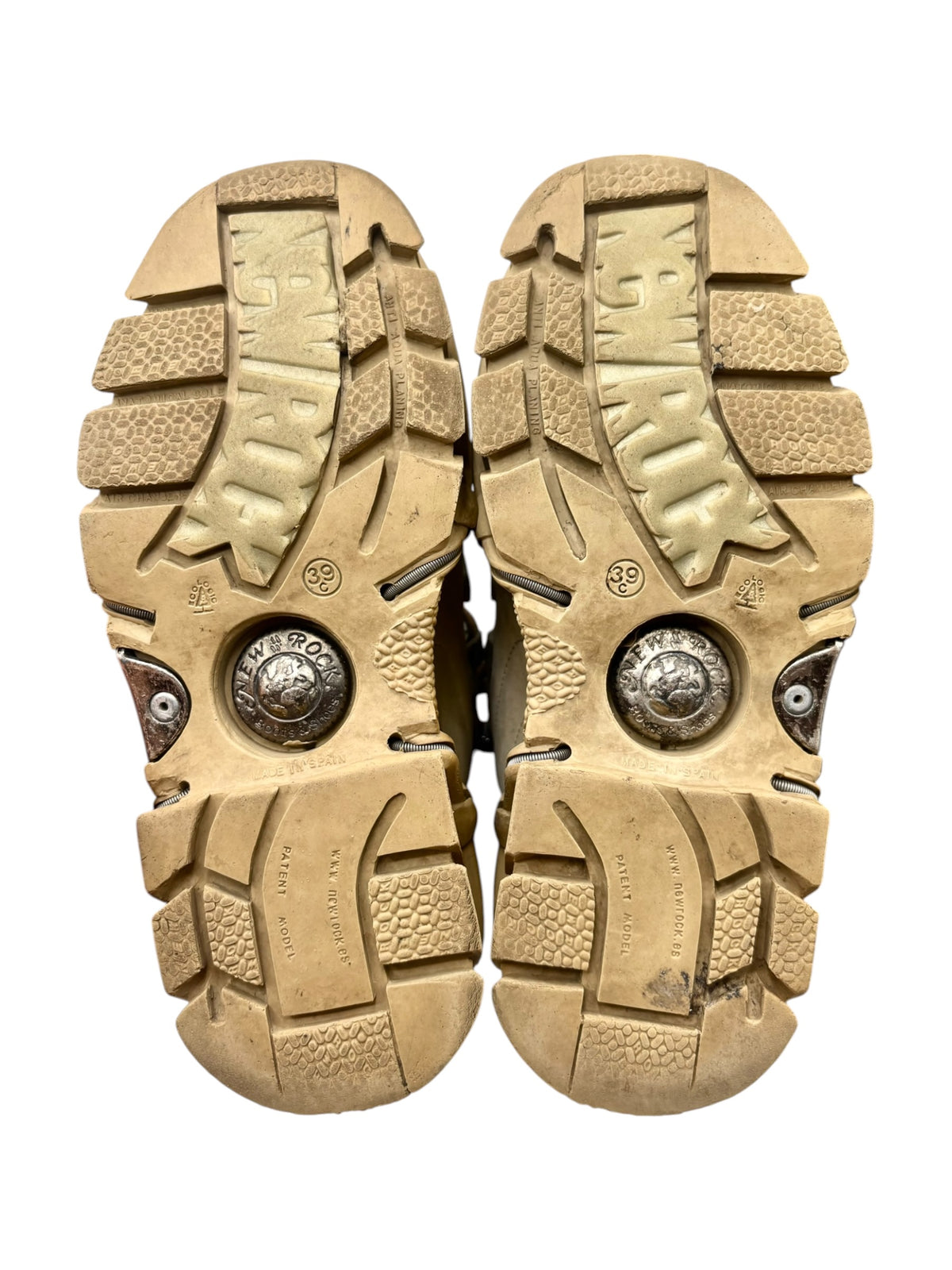 Pair of beige platform boot soles with thick tread and circular metal emblem