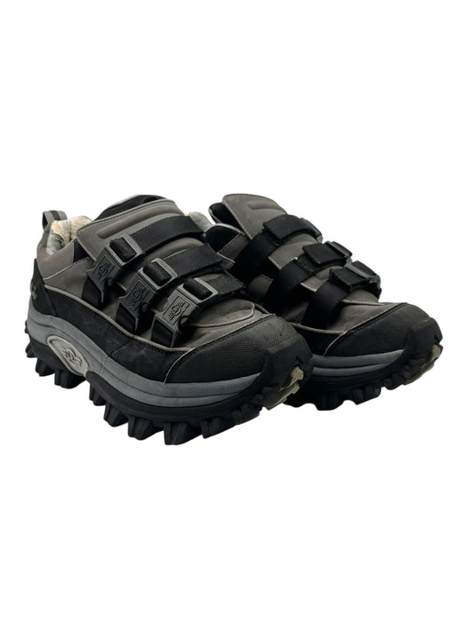 Angled pair view of dark platform boots with wide straps and thick lug sole