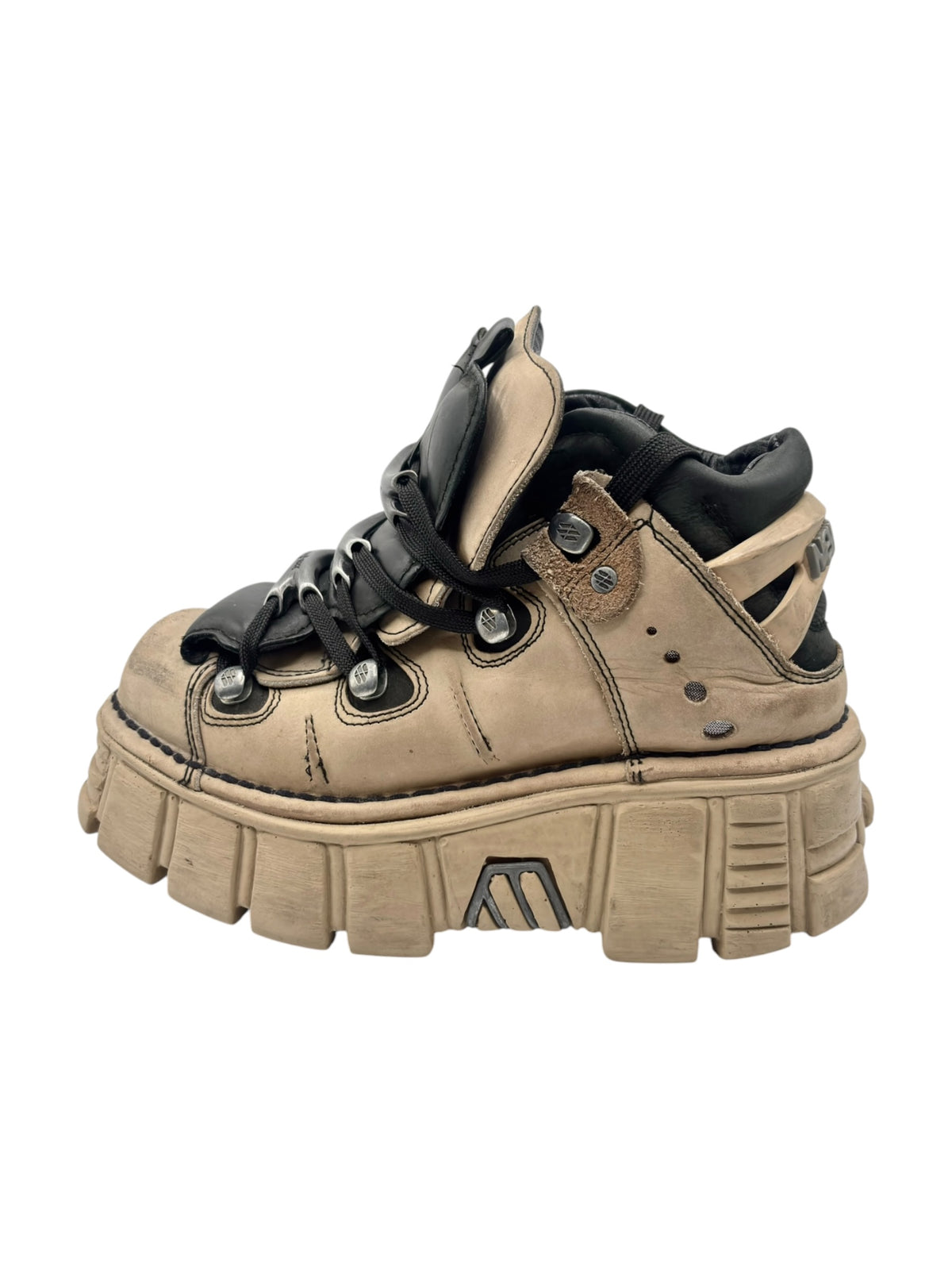Beige and black platform boots with lace-up front and chunky tread sole