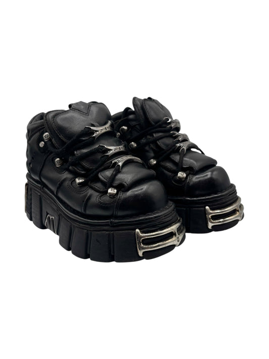Black lace-up platform boots with metal side trim and studded lace hardware