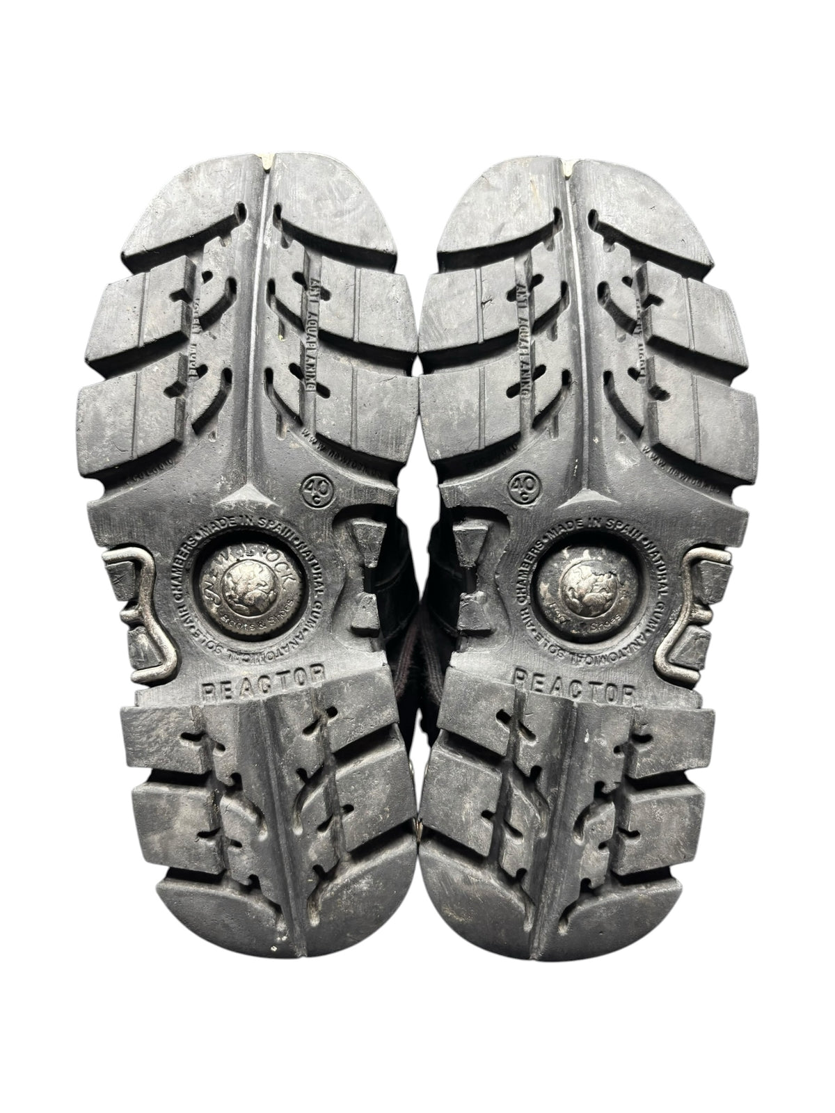Pair of black boot soles showing chunky tread and REACTOR branding
