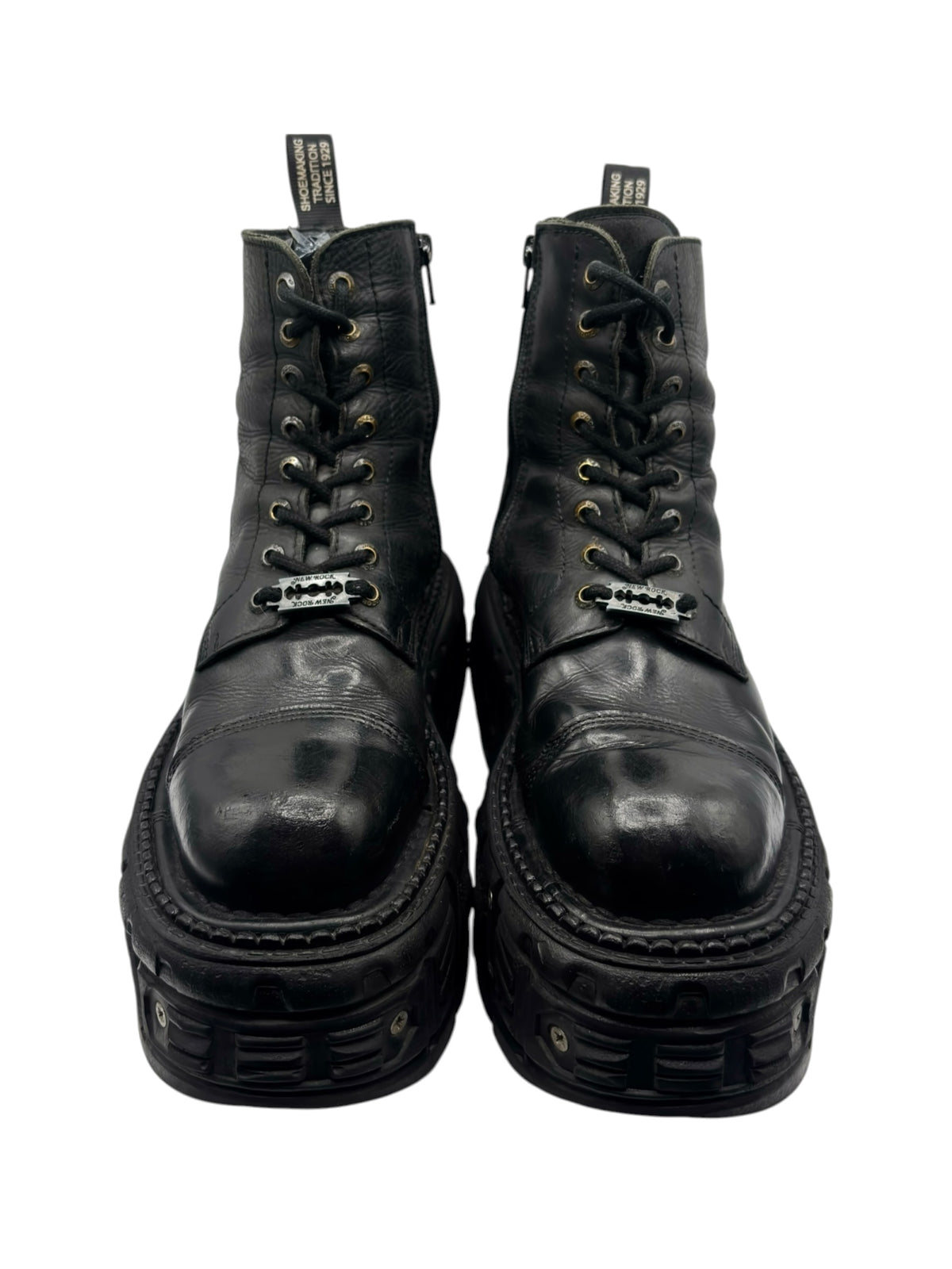 Black lace-up platform boots front view with eyelet lacing and thick lug sole.