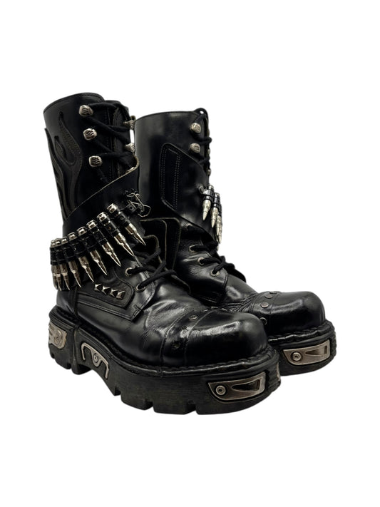Black leather lace-up combat boots with studded strap and metal buckles on thick sole