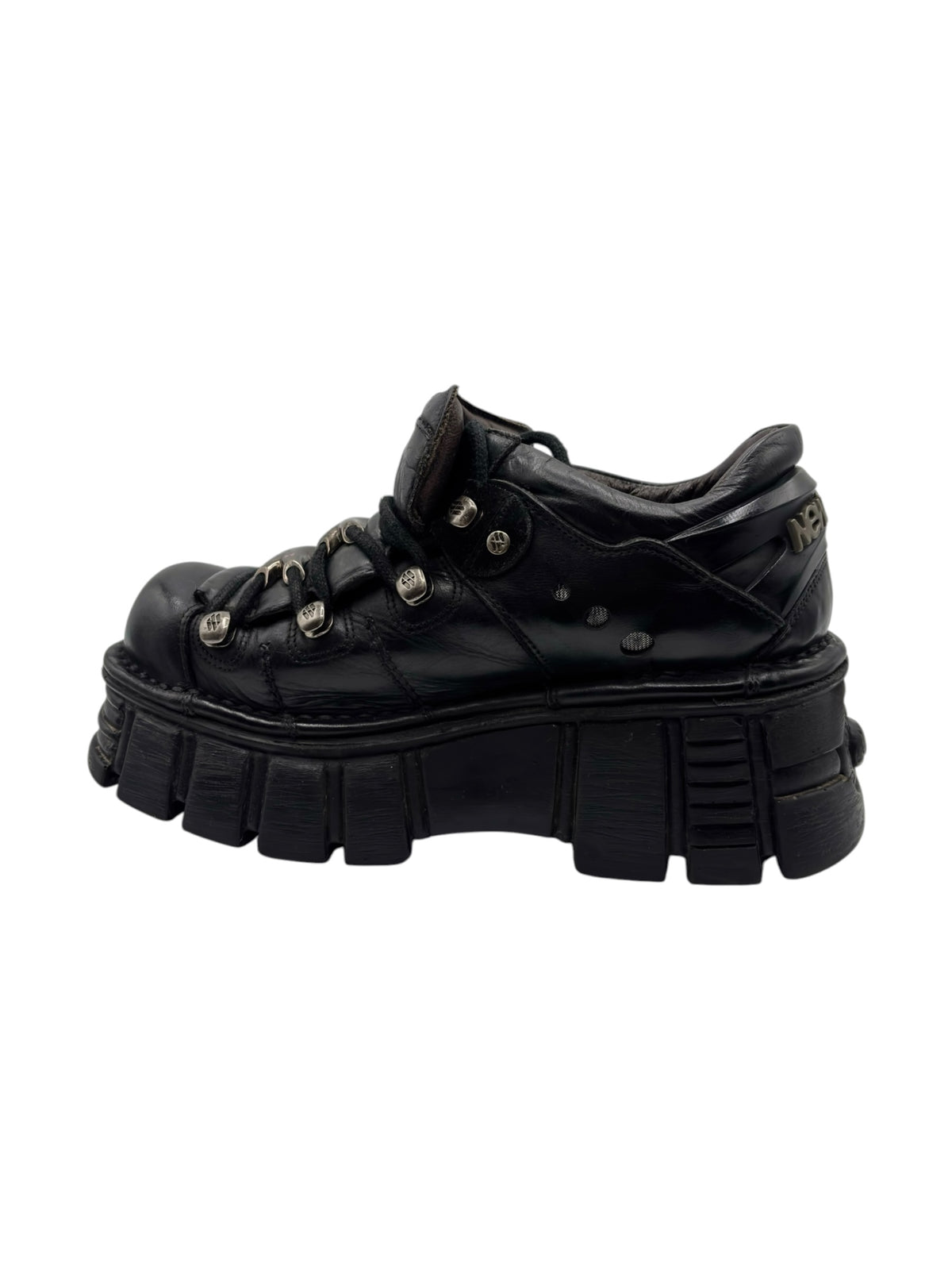 Vintage black leather platform boots with lace-up, small metal studs, and thick tread sole.