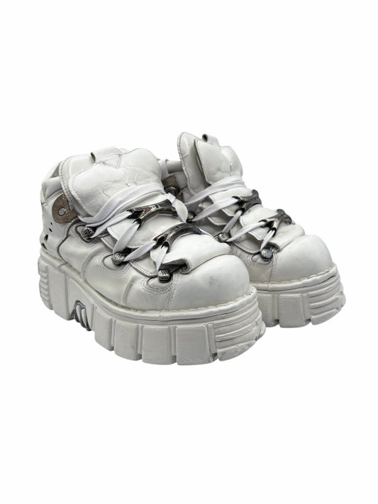 White platform lace-up boots with chunky tread and metal eyelet accents
