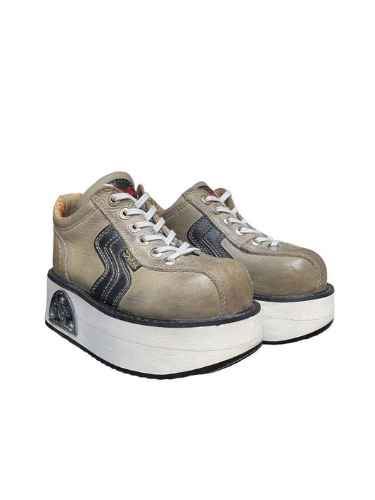 Platform lace-up boots in tan leather with navy side panels and white rubber sole.