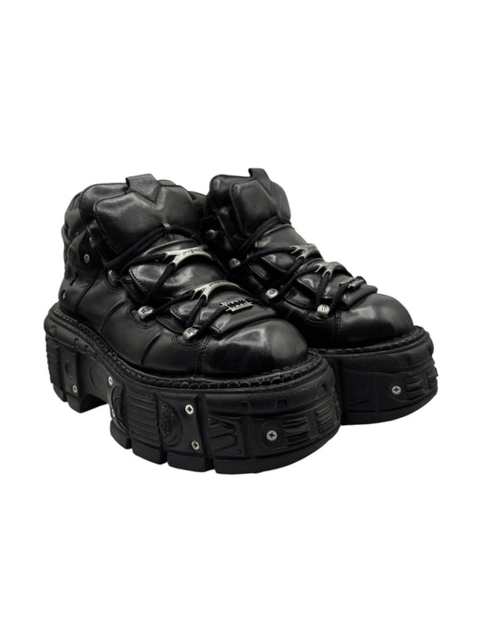 Black leather lace-up platform boots with rounded toe, raised midsole, and side straps.