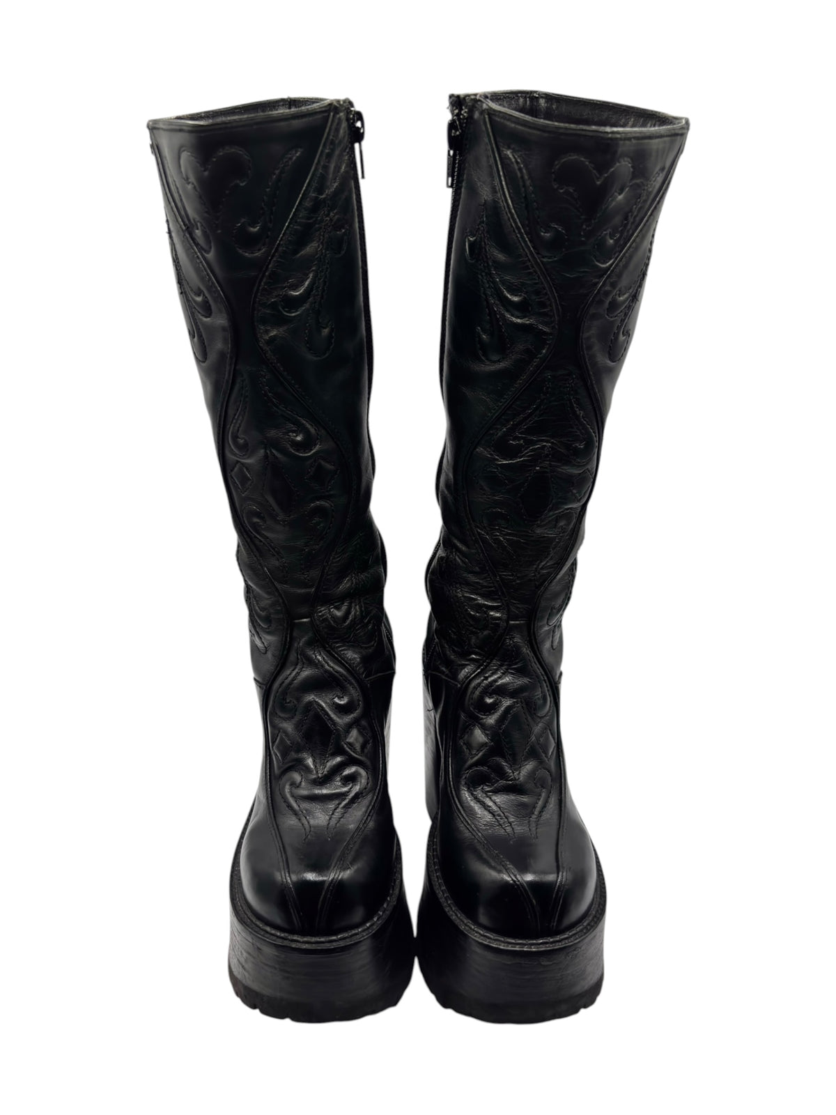 Black knee-high leather boots with side zippers, embossed pattern, platform soles