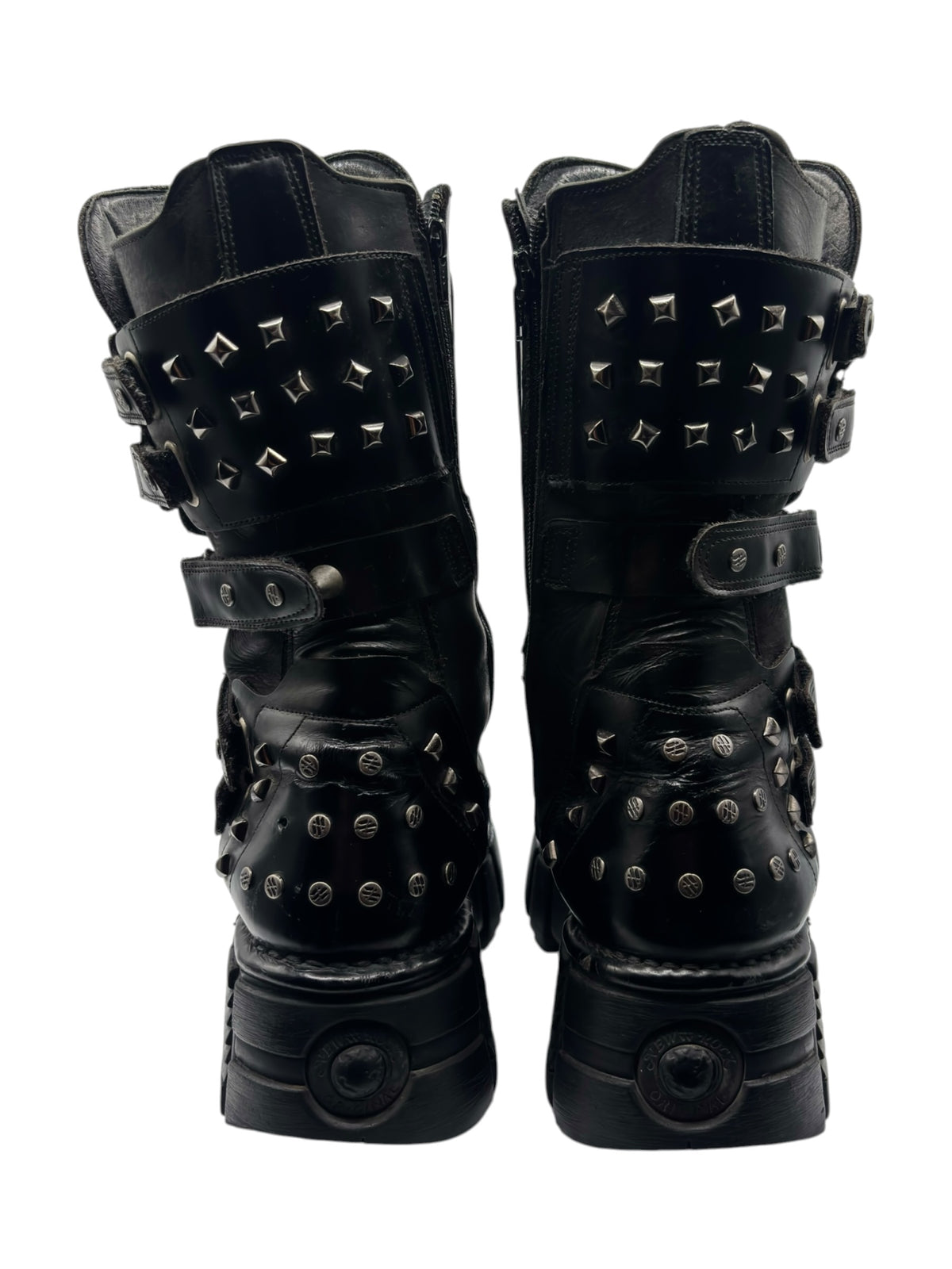 Studded chain platform boots in black, front view with square spike studs and strap details