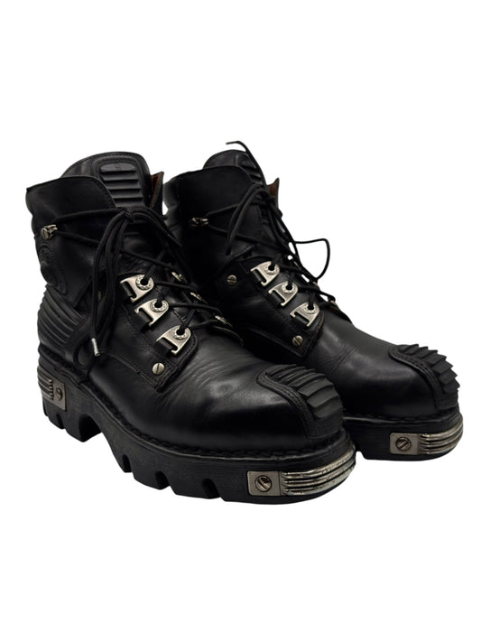 Black lace-up leather platform boots with chunky outsole and metal lace hardware