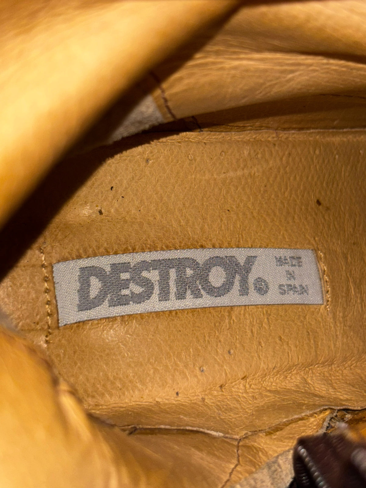 Brown knee-high boot lining with DESIRO label.
