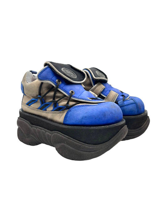 Blue and tan platform boots with lace-up front and thick black lug sole