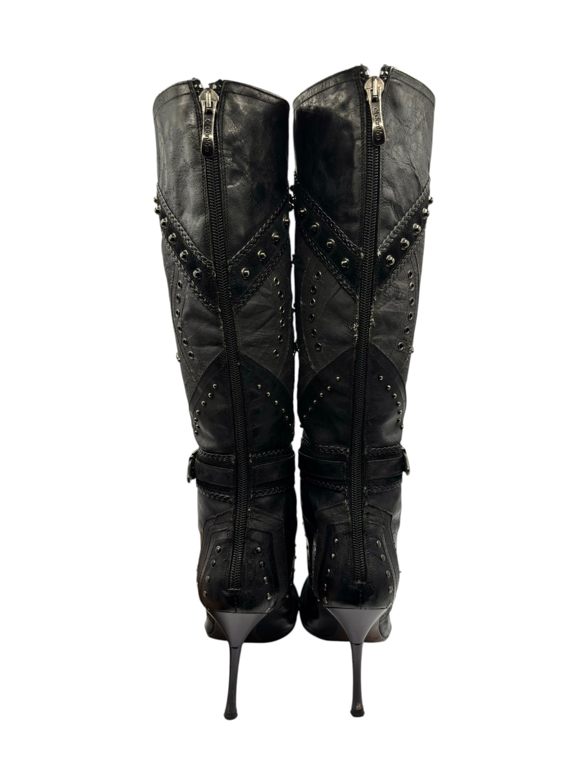 Pair of knee-high boots showing center back seams with full-length zippers and studs