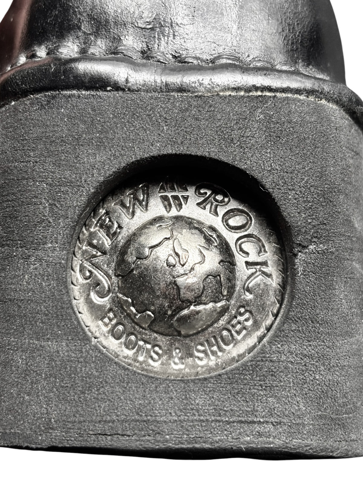 Close-up of New Rock logo medallion on black platform sole