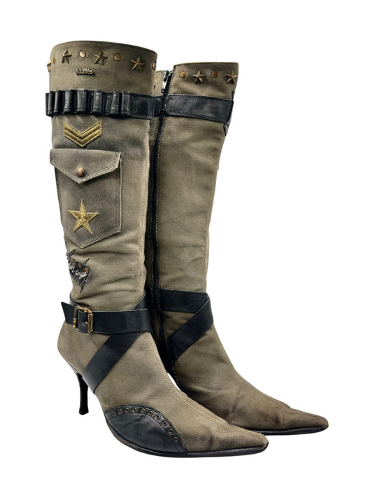 Olive knee-high boots with black straps, patch details, and high heel
