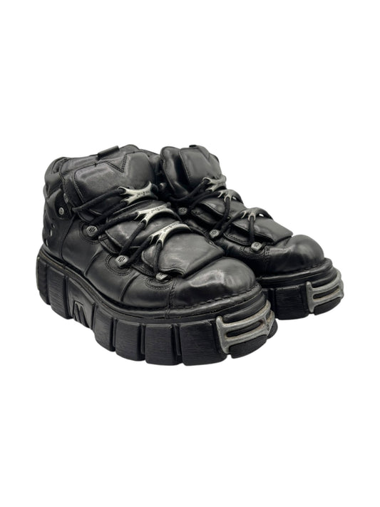 Black platform boots top view with laces, stitched leather, and grippy tread