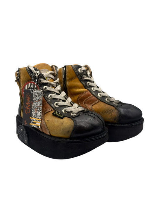 Platform high-top boots in tan and black panels with grey laces and side zipper pull