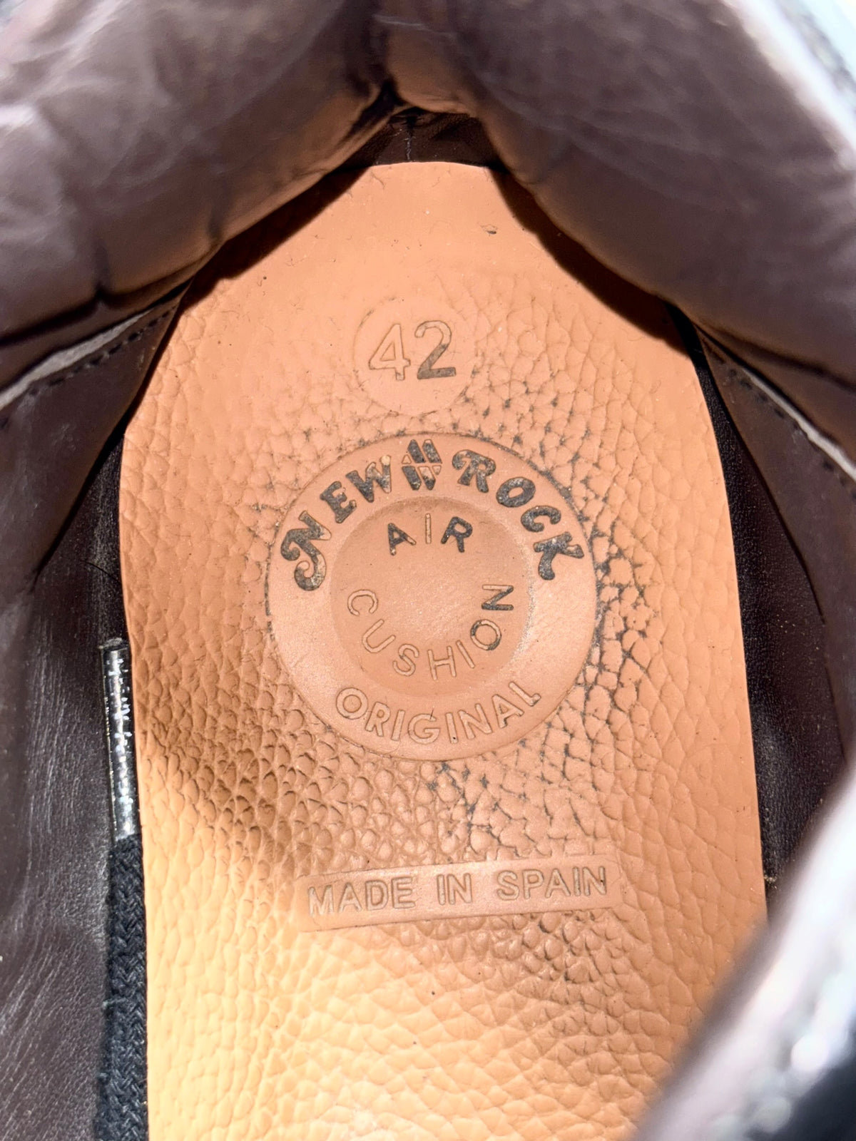 Black leather platform boot footbed with embossed "Made in Spain" label.