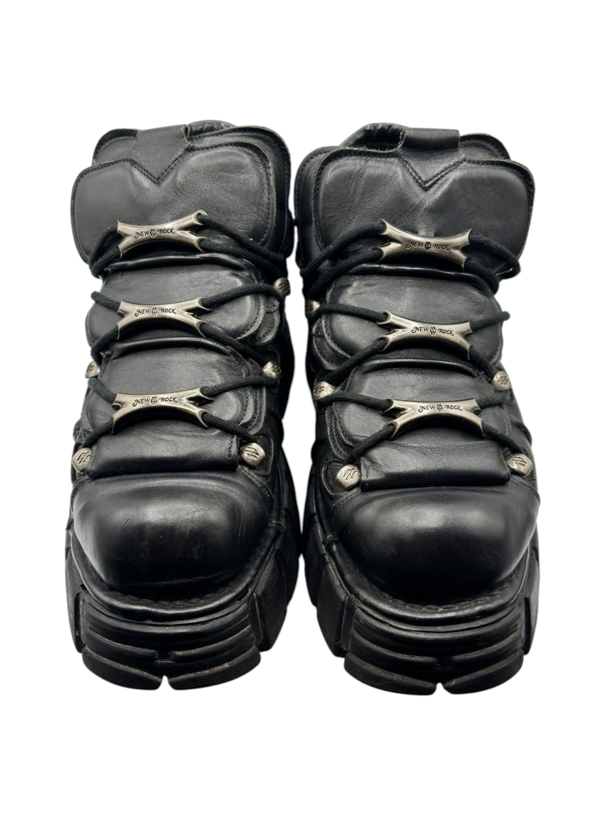 Front view of black platform boots with lace-up ties and worn toe caps