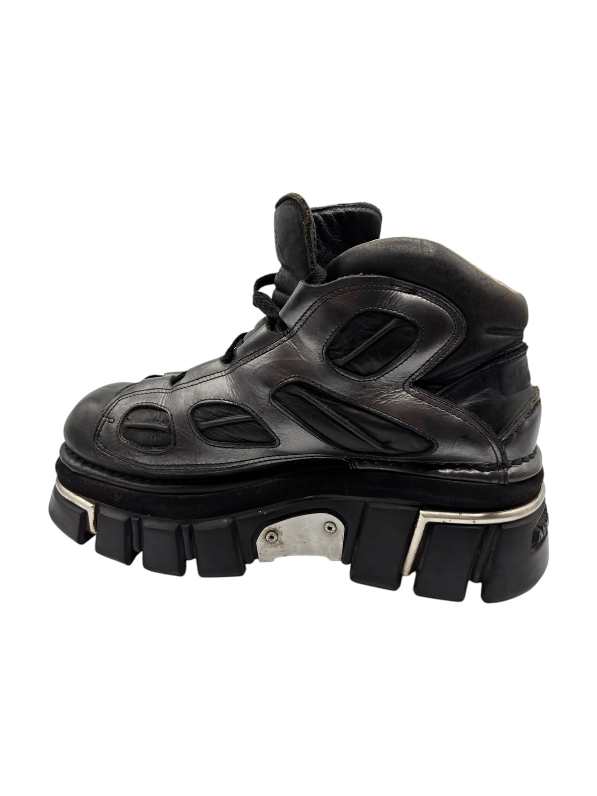 Black leather platform boots angled side view with lug sole and straps