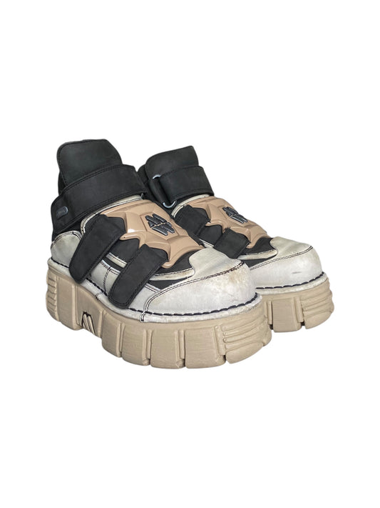 Beige platform boots with black straps, chunky lug sole, velcro closures