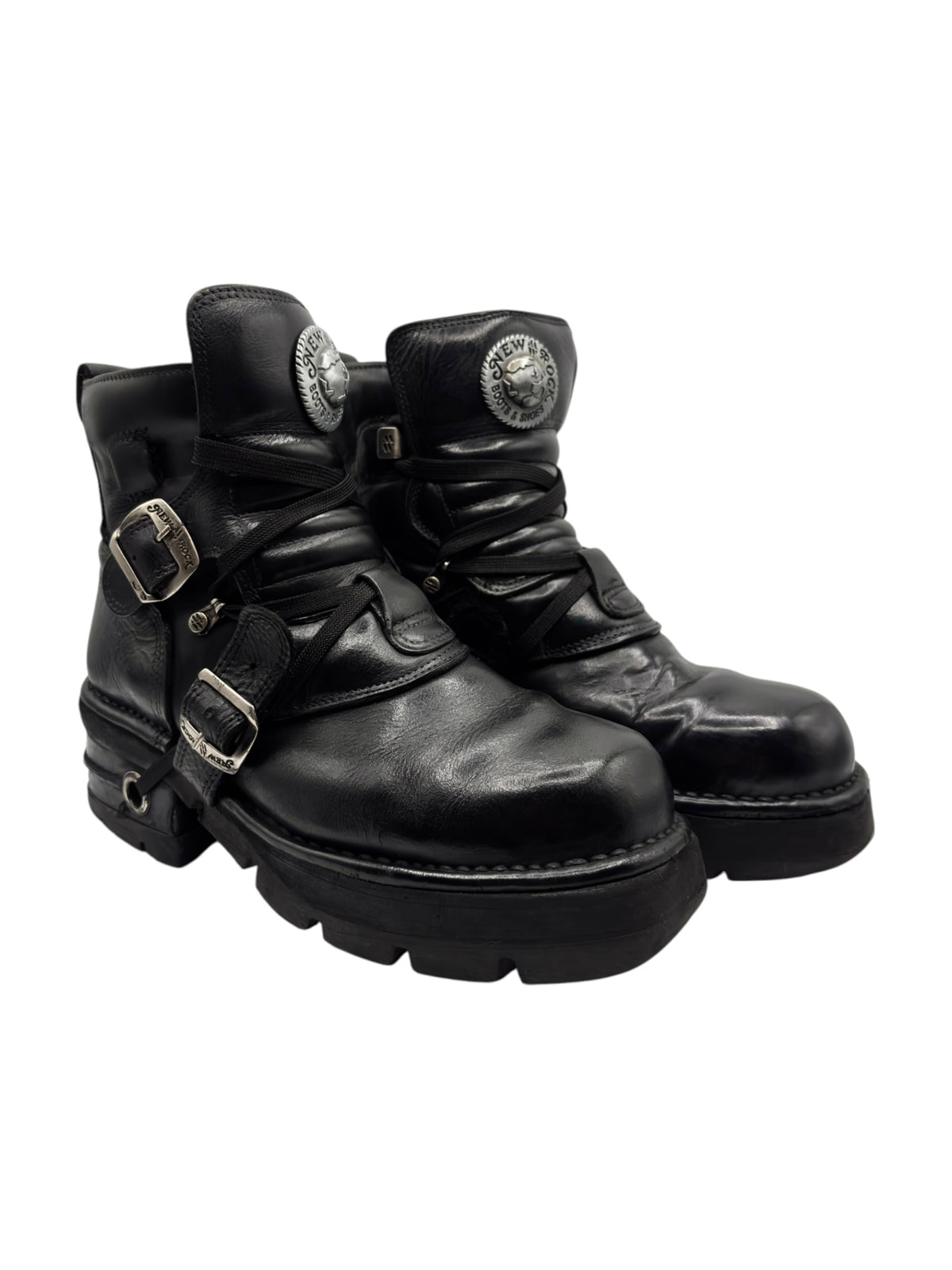 Black leather lace-up boots with raised heel, front buckles, and metal emblem buttons.