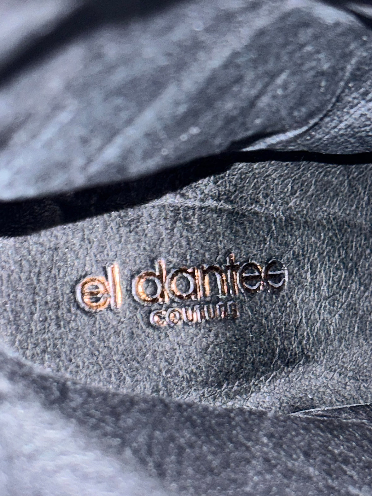 El Dantes knee-high boots with embossed couture logo inside