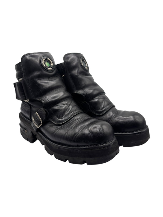 Black leather raised-heel ankle boots with side buckles and padded straps