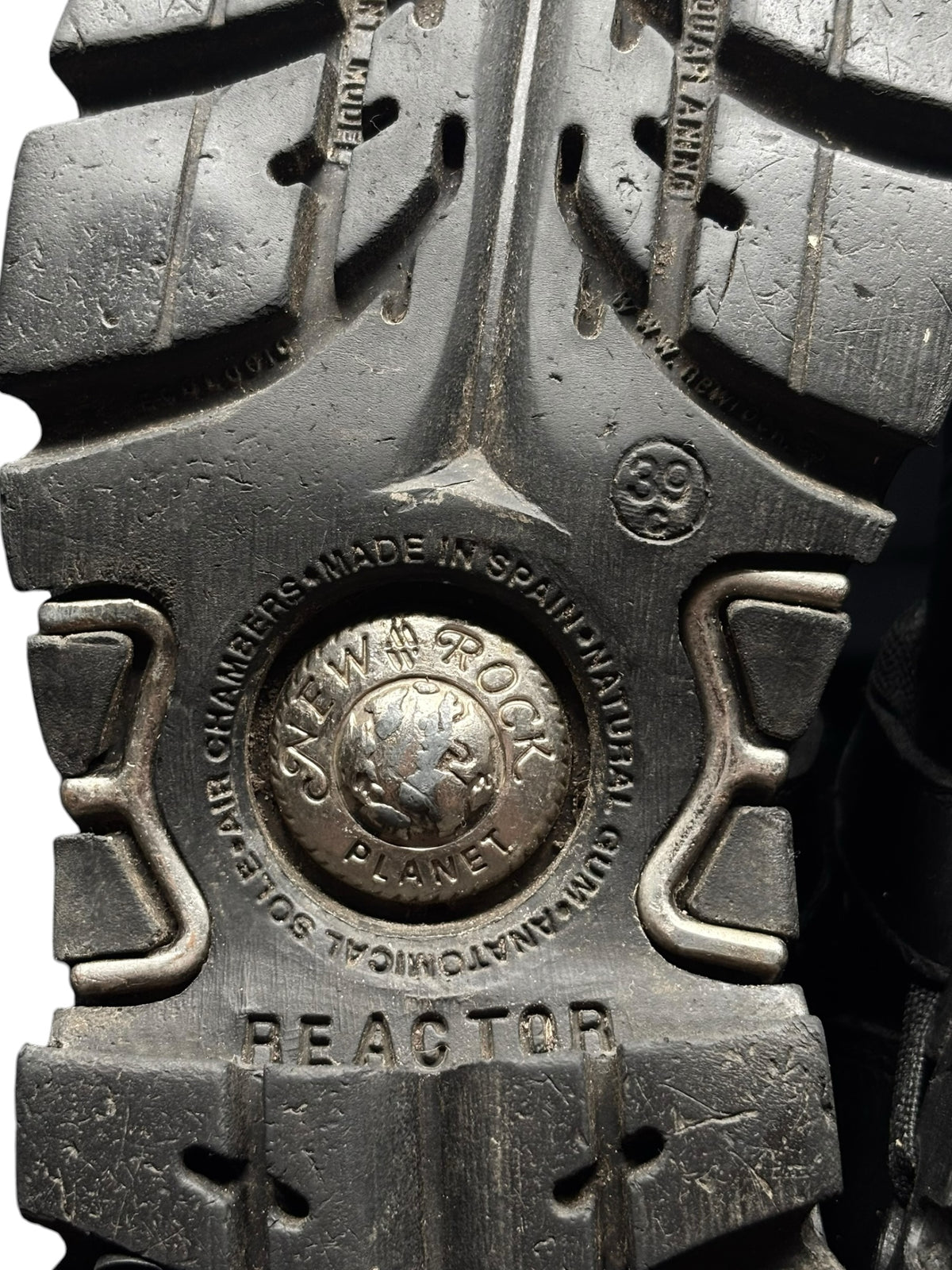 Boot outsole close-up with REACTOR tread and embossed brand marks