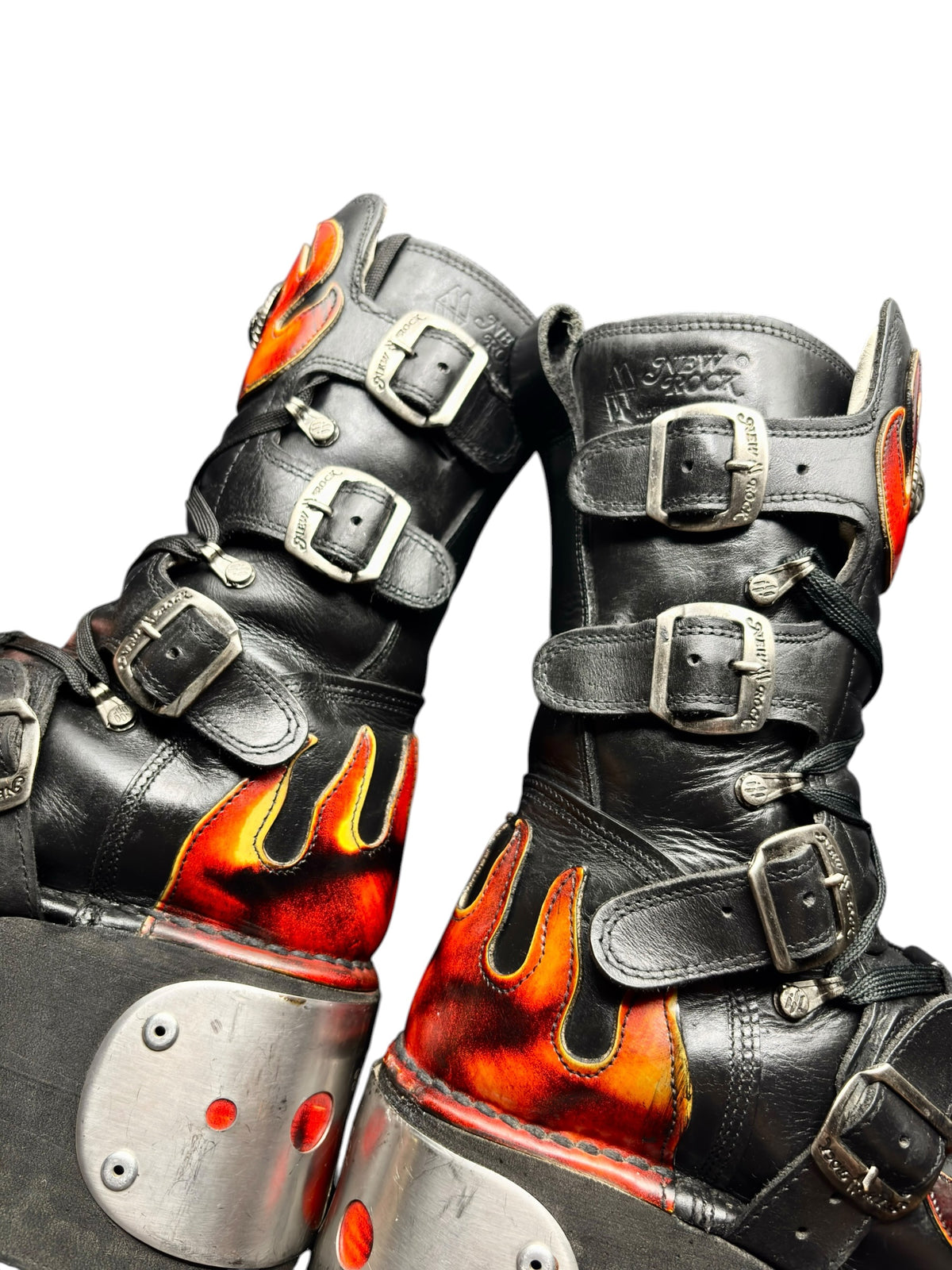 Top view of black flame platform boots showing straps, buckles, and flame side panels.